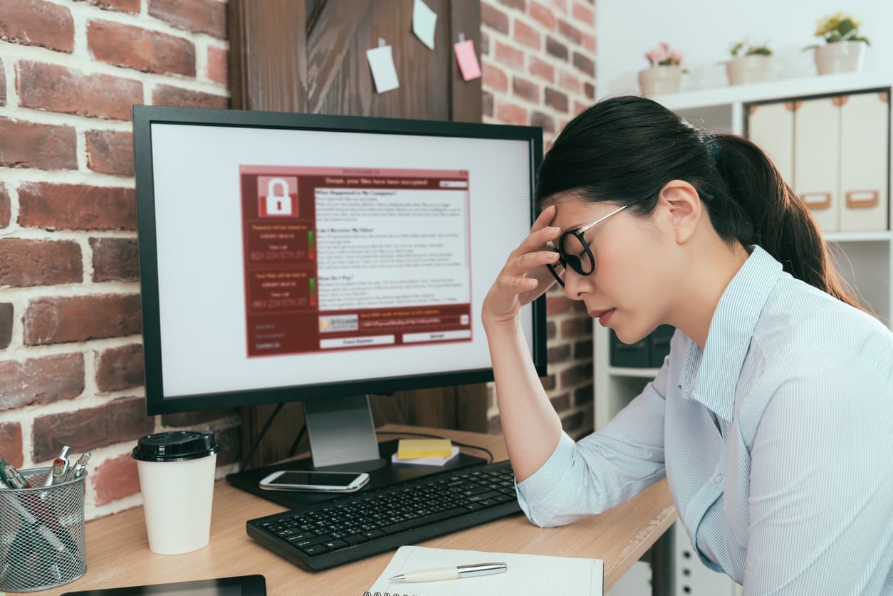 woman finding computer getting virus attack sadness company agent woman finding working computer getting blackmail virus attack thinking solution at office desk and feeling depression.