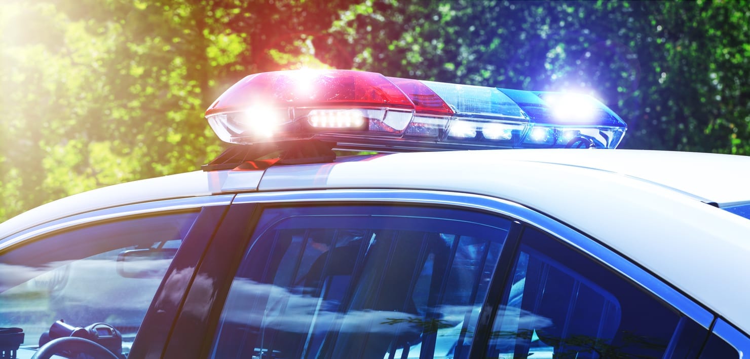 Police car with focus on siren lights. Beautiful siren lights activated in full mission activity. Policemen with patrol car in intervention operation at crime place. Emergency lights flashing on patrol car.