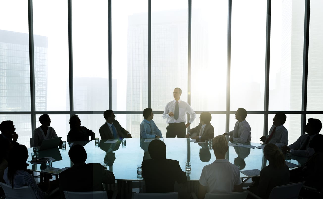 The leader of the business people giving a speech in a conference room.